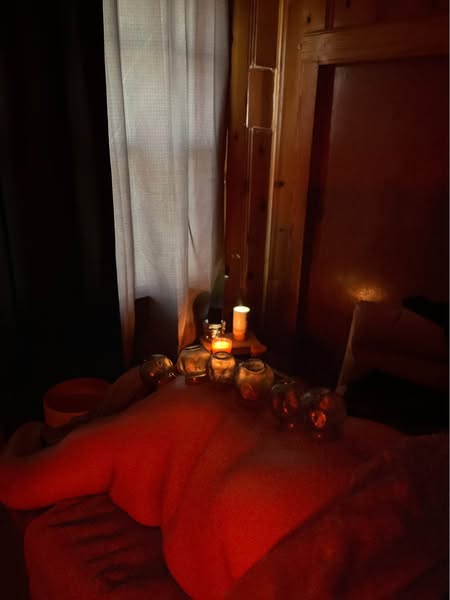 Aura Wellness - Relaxing massage room with ambient candles and warm lighting